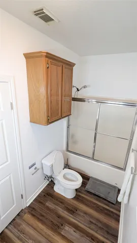 a bathroom with a toilet and a mirror