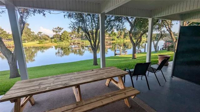 a view of a patio with a table chairs and a backyard