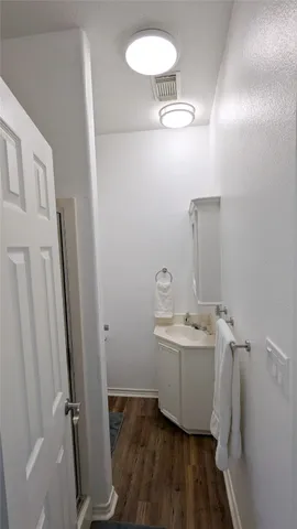 a bathroom with a sink a mirror and vanity
