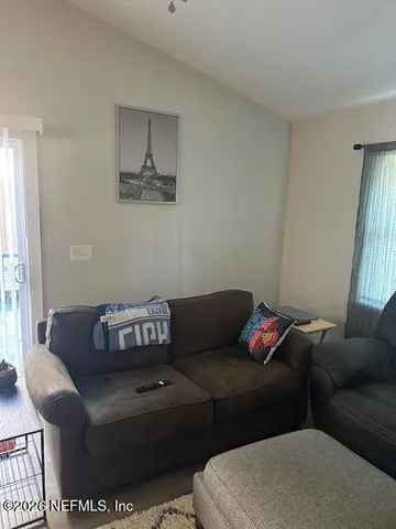 a living room with a couch and a window