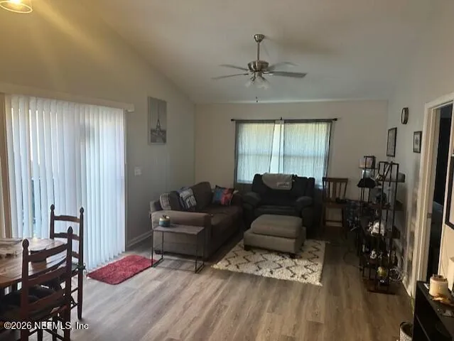 a living room with furniture window and wooden floor
