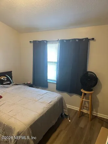 a bedroom with a bed and a chair