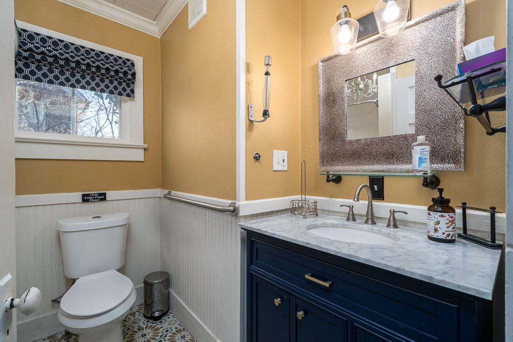 425 West First Street Blue Ridge, GA 30513 - Photo 15 of 33 a bathroom with a granite countertop toilet sink and mirror
