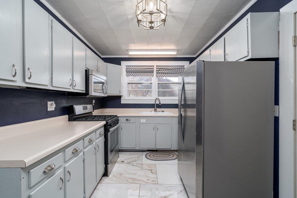425 West First Street Blue Ridge, GA 30513 - Photo 8 of 33 a kitchen with stainless steel appliances granite countertop a washer and dryer
