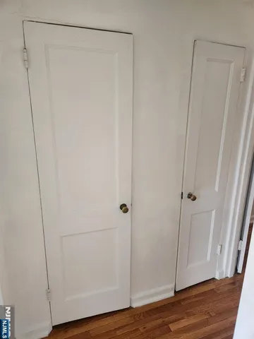 a view of a room with wooden floor