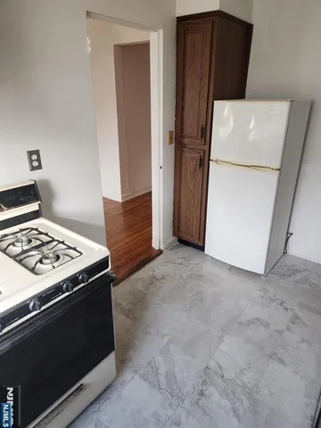 a kitchen with a stove and a refrigerator