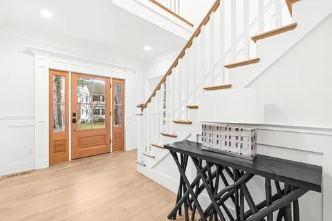 a view of an entryway with wooden floor and stairs