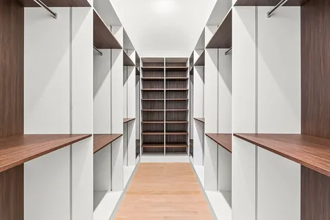 a view of walk in closet with empty racks
