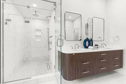 a bathroom with a double vanity sink mirror double shower