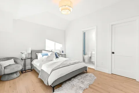 a bedroom with a bed and a night stand