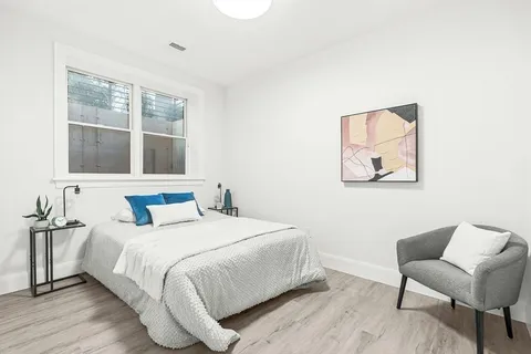 a bedroom with a bed and a large window