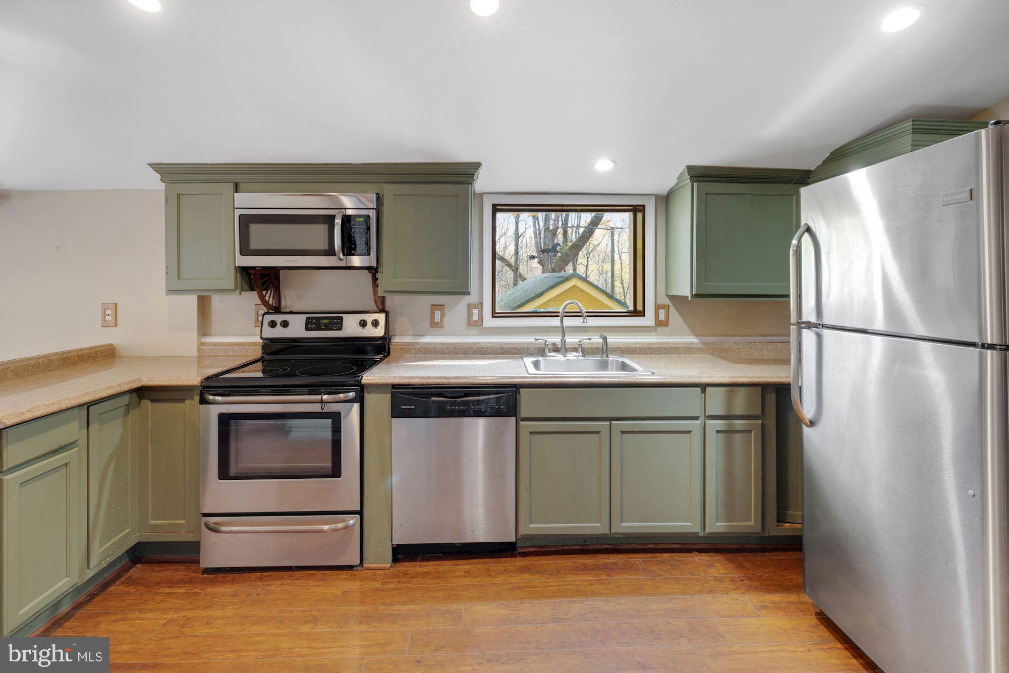 41788 Stumptown Road Leesburg, VA 20176 - Photo 14 of 31 a kitchen with stainless steel appliances granite countertop a stove a refrigerator and a sink