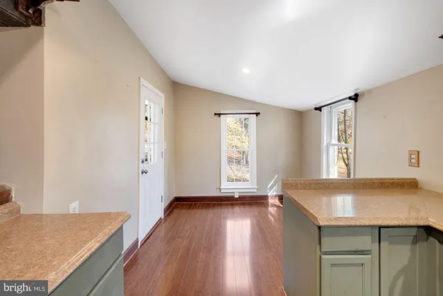 a view of kitchen and hall with wooden floor