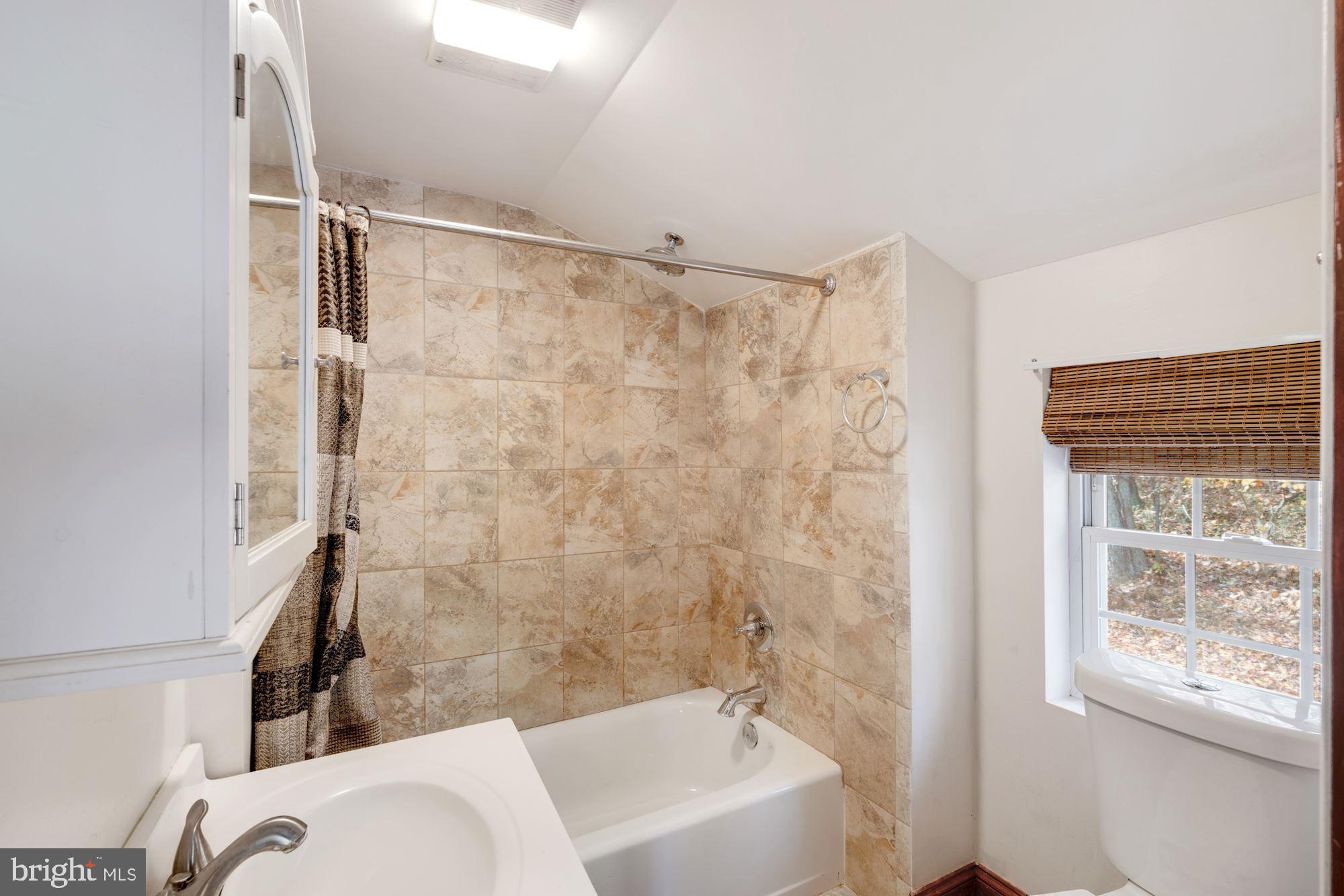 41788 Stumptown Road Leesburg, VA 20176 - Photo 28 of 31 a bathroom with a bathtub and shower