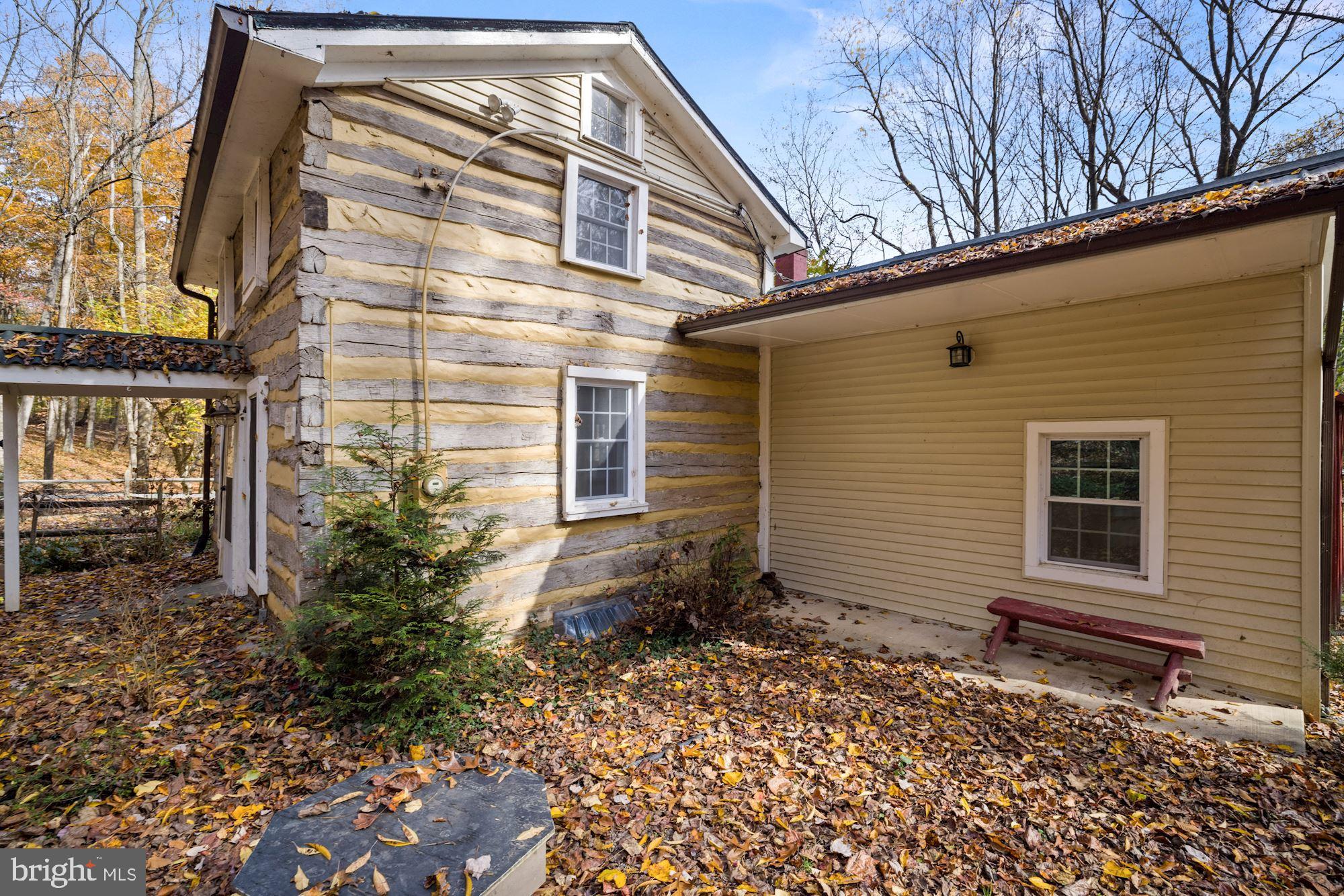 41788 Stumptown Road Leesburg, VA 20176 - Photo 4 of 31 a backyard of a house with large windows and potted plants