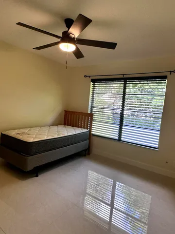 a bedroom with furniture and a large window