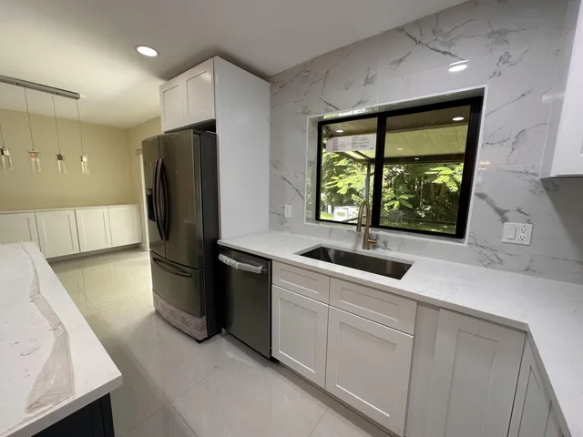 a kitchen with a sink and refrigerator