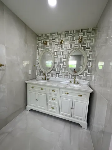 a bathroom with a double vanity sink and a mirror