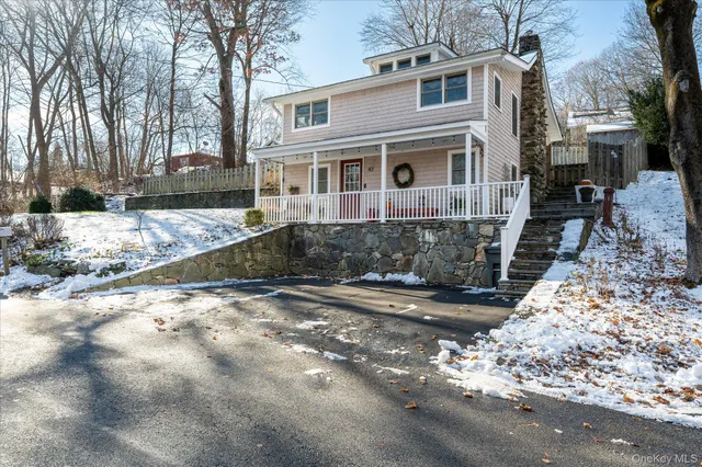 a view of a white house with a yard covered in snow