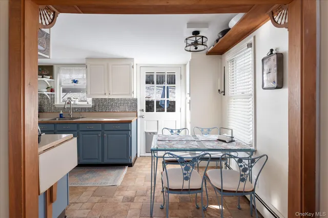 a kitchen with a sink cabinets and dining table