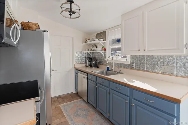 a kitchen with a sink and cabinets