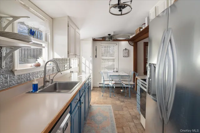 a kitchen with a refrigerator and a sink
