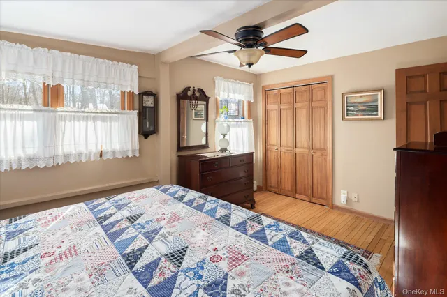 a bedroom with a bed dresser and a window