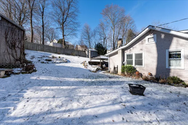 a view of a backyard with snow on the road