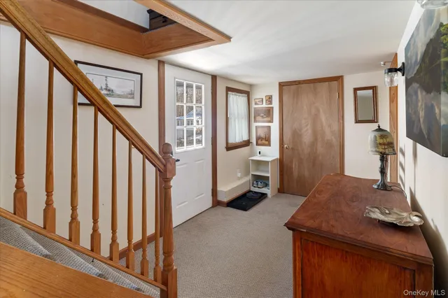 a view of a livingroom with furniture and stairs
