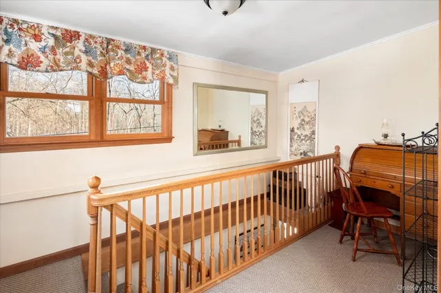 a view of a hallway with seating area