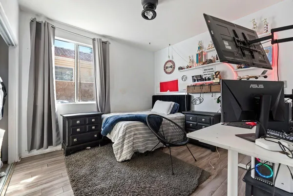a bedroom with bed and a window