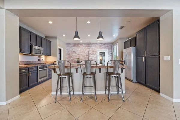 a large kitchen with a table and chairs