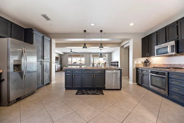 a kitchen with refrigerator and cabinets
