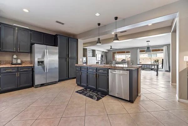 a kitchen with cabinets and stainless steel appliances