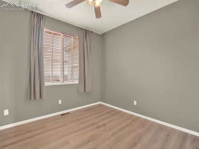 a view of an empty room and wooden floor