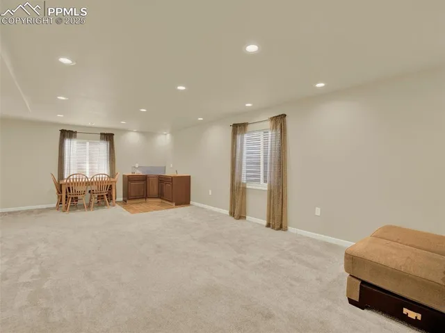 a view of a hall with dining room and furniture