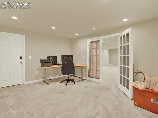 a view of a workspace with furniture and a window