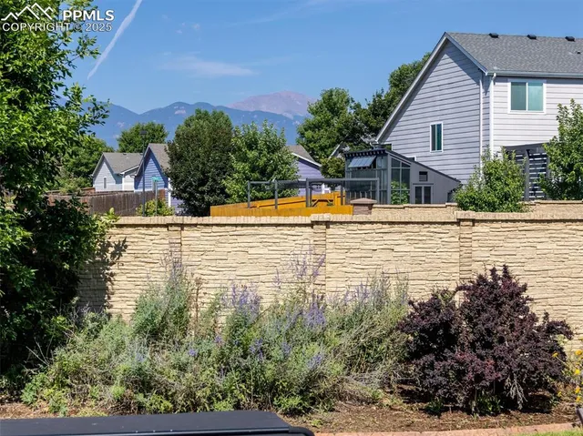 a view of a patio with chairs and a table
