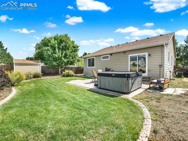 an aerial view of residential houses with outdoor space and trees
