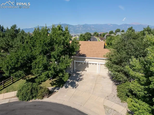 an aerial view of a house with swimming pool and patio