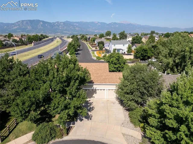 an aerial view of a house with swimming pool a yard and lake view