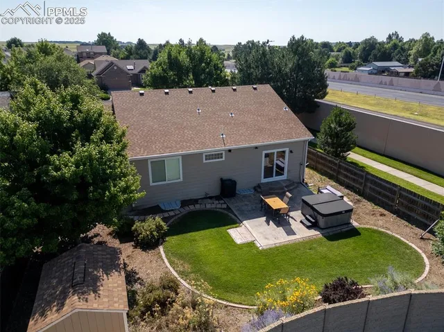 an aerial view of a house with swimming pool garden and patio