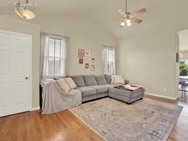 a living room with furniture couches and a window