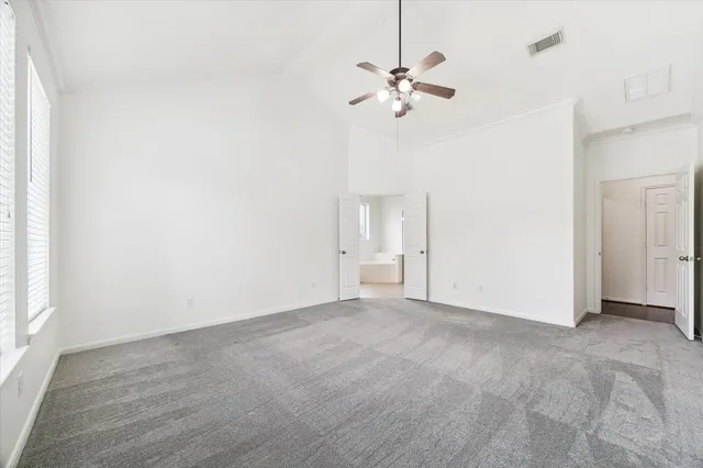 a spacious bathroom with a granite countertop sink mirror and shower
