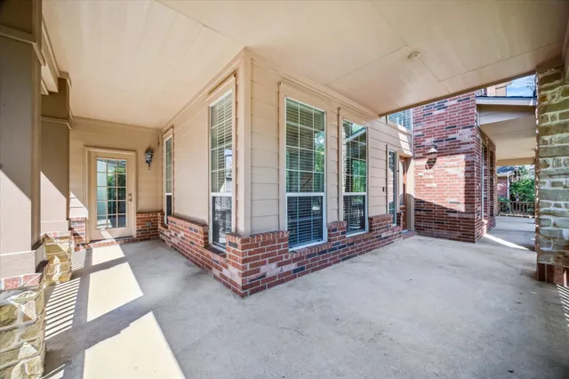 a living room with furniture gym equipment and a large window