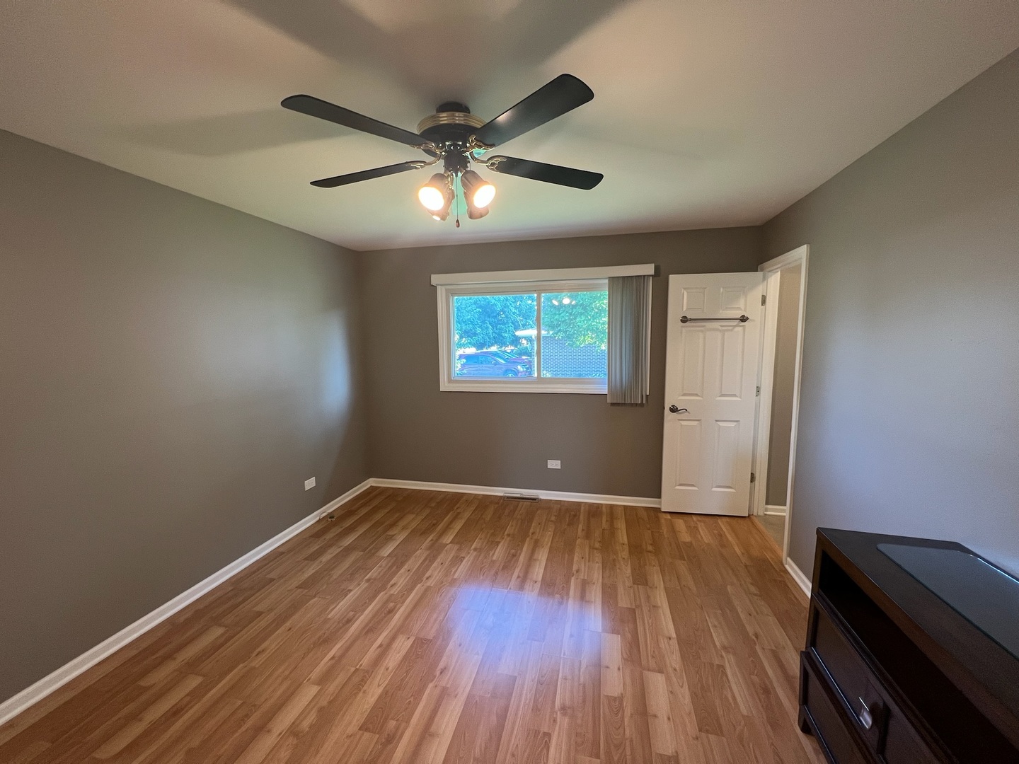 548 Delaware Trail Carol Stream, IL 60188 - Photo 14 of 26 an empty room with wooden floor fan and windows