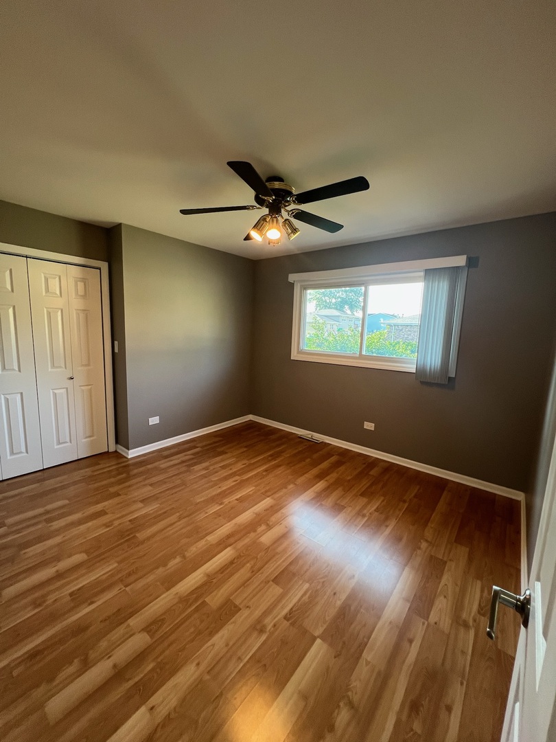 548 Delaware Trail Carol Stream, IL 60188 - Photo 16 of 26 an empty room with wooden floor and windows