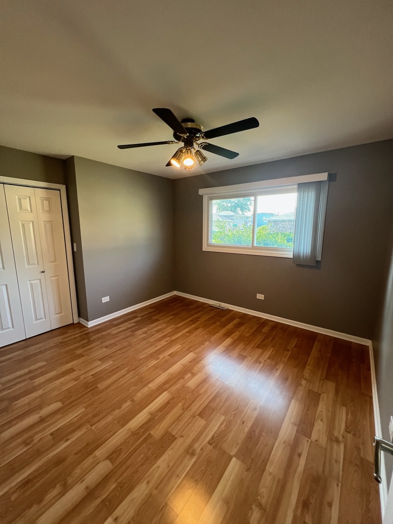 548 Delaware Trail Carol Stream, IL 60188 - Photo 17 of 26 an empty room with wooden floor and windows