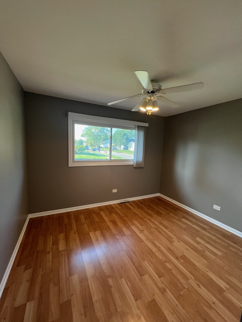 548 Delaware Trail Carol Stream, IL 60188 - Photo 19 of 26 wooden floor in an empty room with a window