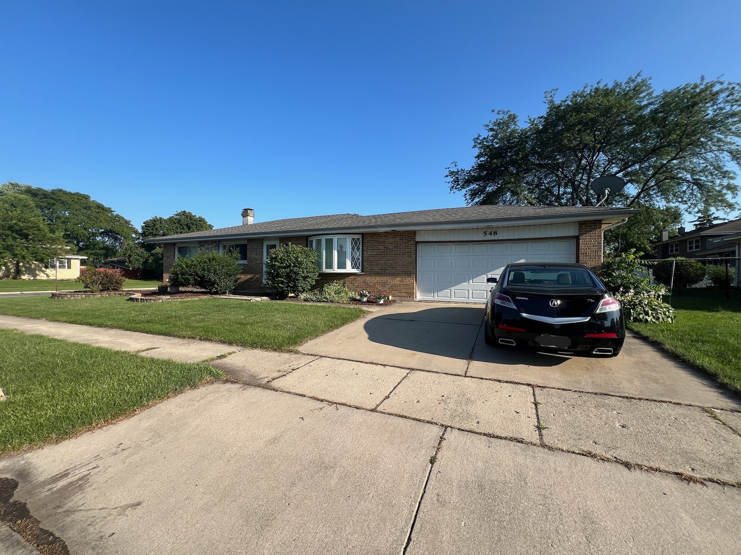 548 Delaware Trail Carol Stream, IL 60188 - Photo 2 of 26 a car parked in front of a house with yard